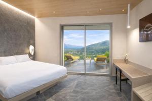 a bedroom with a bed and a balcony with a view at Le Stele Hotel in Lerici