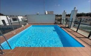 a swimming pool on the roof of a house at Serenity Gelves in Gelves