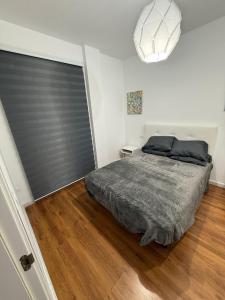 a bedroom with a bed and a large window at Serenity Gelves in Gelves +16 photos