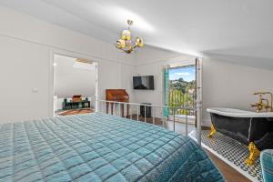 a bedroom with a bed and a tub and a window at Villa Atajate Secret by SuperHosts in Atajate +26 photos