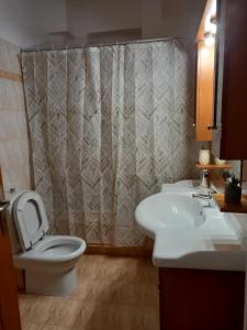a bathroom with a toilet and a sink and a shower at Marbi Apartment in Tripoli