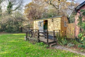 an old rv is sitting in a yard at The Hideaway at Duffryn Mawr Self Catering Cottages in Cowbridge