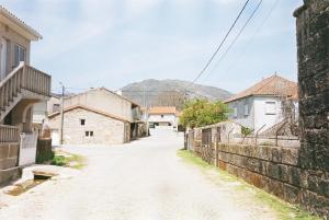 an empty street in a town with mountains in the background at Casa do Sobrado-Gralhas-Montalegre in Gralhas