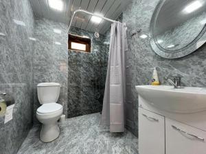 a bathroom with a toilet and a sink and a mirror at Home Comfort in Kotaykʼ +10 photos