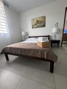a bedroom with a bed with a box on it at Heshima's Apartment for Business in Macouria