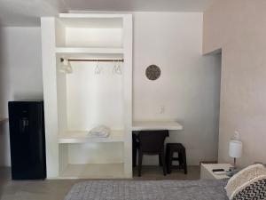 a living room with a desk and a chair at Habitat in Barra de Navidad