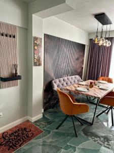 a dining room with a table and a couch at GZP Residence Lugoj in Lugoj
