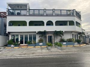 a white building with plants in front of it at BethsAida Conference Center & Boutique Accommodations in Simpson Bay