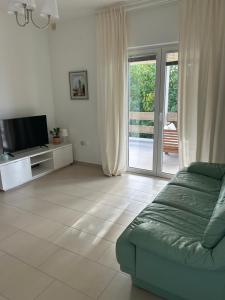 a living room with a couch and a television at Zara 1 in Kruševo +9 photos