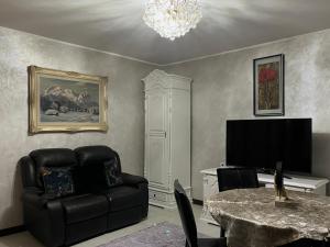 a living room with a black couch and a table at Casa Adi Sucevița in Voivodeasa +30 photos