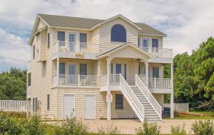 a large house with stairs on the side of it at King BEEch - Southern Shores, 300 Yds to Beach, Ocean View, Pool, Hot Hub, Fenced Yard in Southern Shores