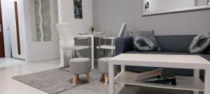 a living room with a couch and a table at Wohnung an der Lagune in Büsum