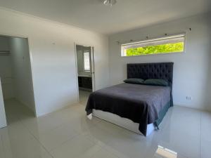 a bedroom with a bed with a window above it at Master's bedroom in Mount Duneed in Mount Duneed