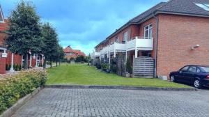 a brick house with a car parked in front of it at Wohnung an der Lagune in Büsum