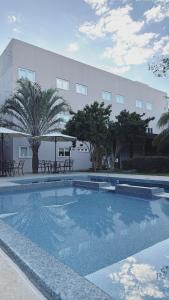 a large swimming pool in front of a building at BALSAS PREMIER HOTEL in Balsas