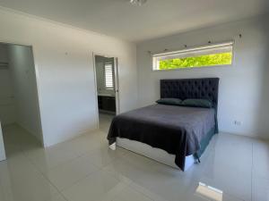 a bedroom with a bed with a window above it at Master's bedroom in Mount Duneed in Mount Duneed +4 photos