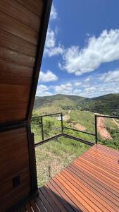 a view from the deck of a house with a view at Chalé Vale da Cachoeira in Três Rios +18 photos