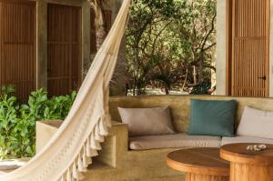 eine Hängematte auf der Veranda eines Hauses in der Unterkunft UtopiAmar Beach House & Suites in Playa Agua Blanca