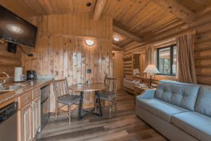 a kitchen and living room in a log cabin at Cowboy Village Resort in Jackson