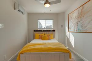 a bedroom with a bed with orange and yellow pillows at Great for Digital Nomads! Convenient Manteca Apt in Manteca