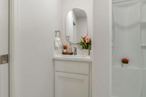 a bathroom with a white sink and a mirror at Great for Digital Nomads! Convenient Manteca Apt in Manteca +16 photos