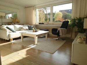 a living room with a couch and a table at Ferien am See in Möhnesee +46 photos