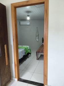 a view of a room with a bed and a chair at SUÍTE Botos De Alter in Alter do Chao +3 photos