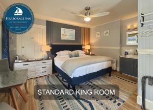 a large bedroom with a bed and a bathroom at Harborage Inn on the Oceanfront in Boothbay Harbor