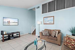 a living room with a couch and a table at Emerald Breeze in Destin