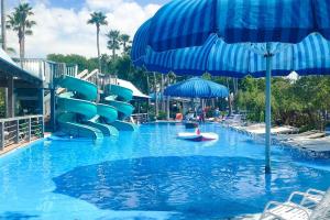 a water park with a water slide and an umbrella at Emerald Breeze in Destin