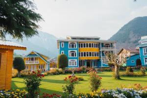 a row of colorful houses with a garden at Pahalgam Resort and Cottages in Pahalgām +27 photos