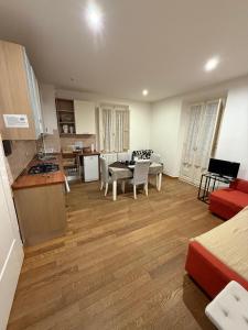a room with a kitchen and a living room with a table at Sotto il Borgo Apartments in Iesi