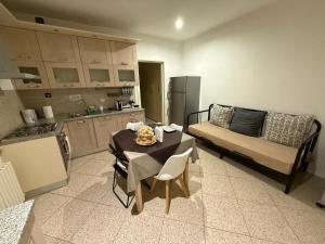 a kitchen and a living room with a table and a couch at Sotto il Borgo Apartments in Iesi