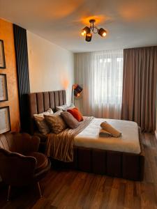 a bedroom with a large bed with pillows on it at GZP Residence Lugoj 21 in Lugoj