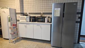 a refrigerator and cabinets in a kitchen with appliances at Mendes Residence in Belém