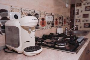 a white mixer sitting on a counter next to a stove at Apartament Andreas - centru, confort si relaxare in Arad +29 photos