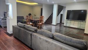 a living room with a large couch and a table at Mendes Residence in Belém