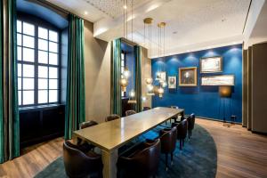 a conference room with a long table and chairs at Motel One Magdeburg in Magdeburg