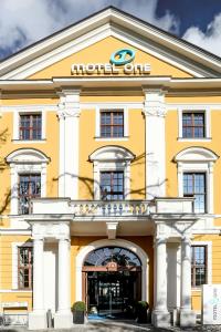 a yellow building with the hotel one at Motel One Magdeburg in Magdeburg