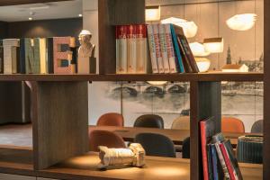 a book shelf with books and a fire hydrant on it at Motel One Dresden-Palaisplatz in Dresden