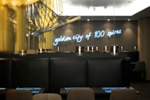 a dining room with chairs and a sign that reads cala city of stories at Motel One Prague-Florentinum in Prague