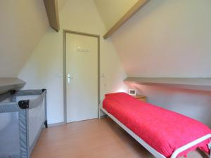 a small room with a red bed in a attic at Chalet in Tyrol near Ski Slope in Stramproy