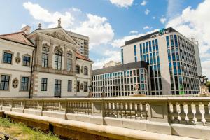 a bridge over a river in a city with buildings at Motel One Warsaw-Chopin in Warsaw