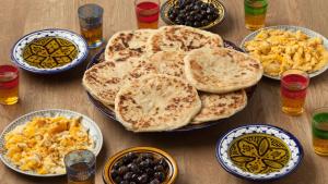 a table with plates of food and bowls of breakfast foods at Villa Soliya 4 Rooms with private pool in Marrakesh