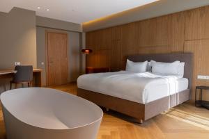 a hotel room with a large bed and a desk at MontiSio Boutique Hotel in Gudauri +35 photos