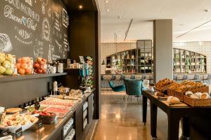 a bakery with a bunch of food on display at Motel One Barcelona-Ciutadella in Barcelona +27 photos