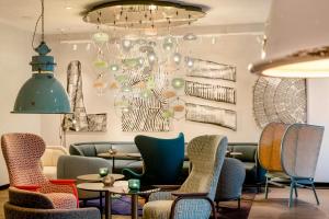 a room with chairs and a table and a chandelier at Motel One Linz-Hauptplatz in Linz +31 photos