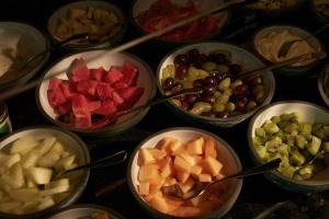 a table topped with bowls of different types of fruit at The Cloud One Prague in Prague