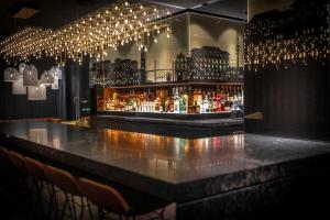 a bar in a restaurant with a bunch of lights at The Cloud One Hamburg-Kontorhaus in Hamburg