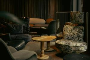 a living room with chairs and a table and a couch at The Cloud One Gdansk in Gdańsk